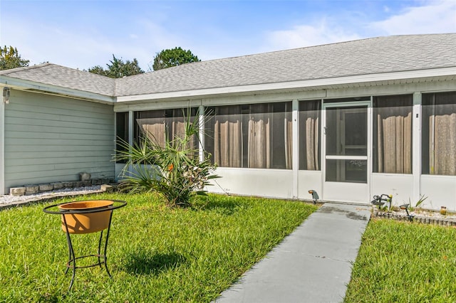 exterior space featuring a yard and a sunroom