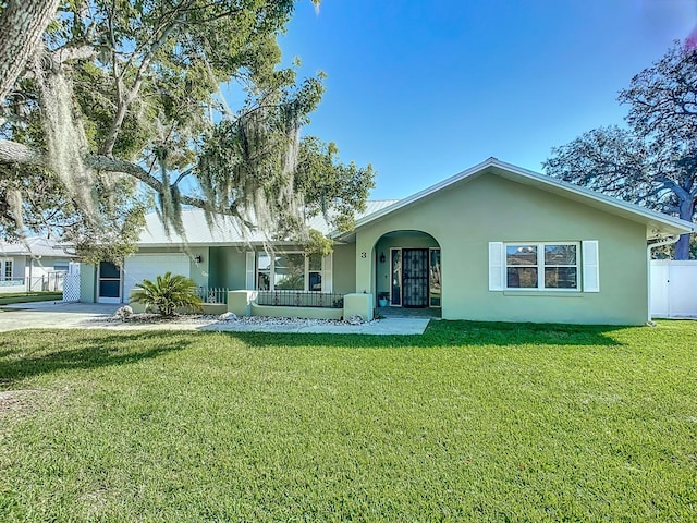 back of property with a yard and a garage