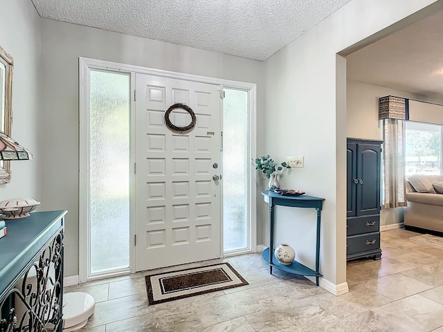 foyer featuring a textured ceiling