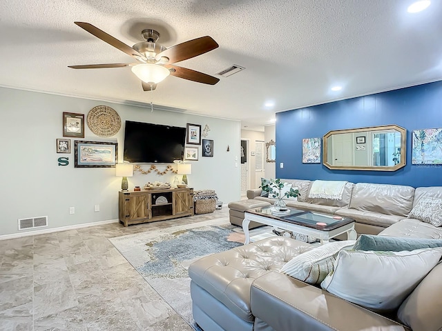 living room featuring ornamental molding, a textured ceiling, and ceiling fan