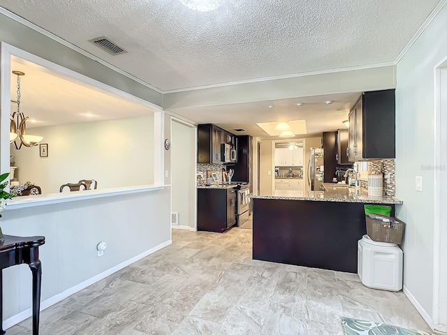 kitchen with light stone countertops, appliances with stainless steel finishes, sink, backsplash, and kitchen peninsula