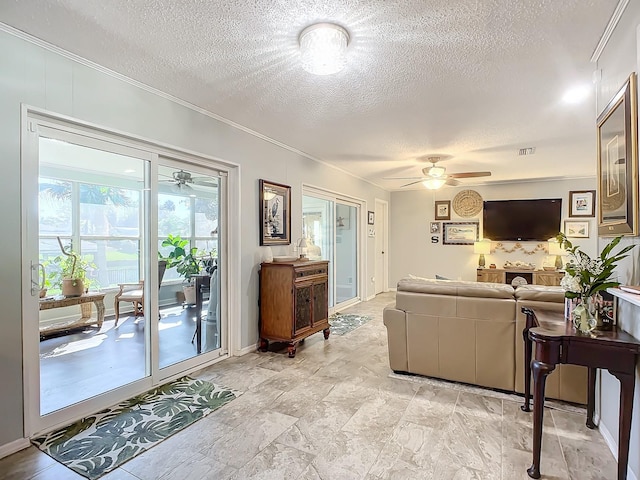 living room featuring crown molding, a textured ceiling, and ceiling fan