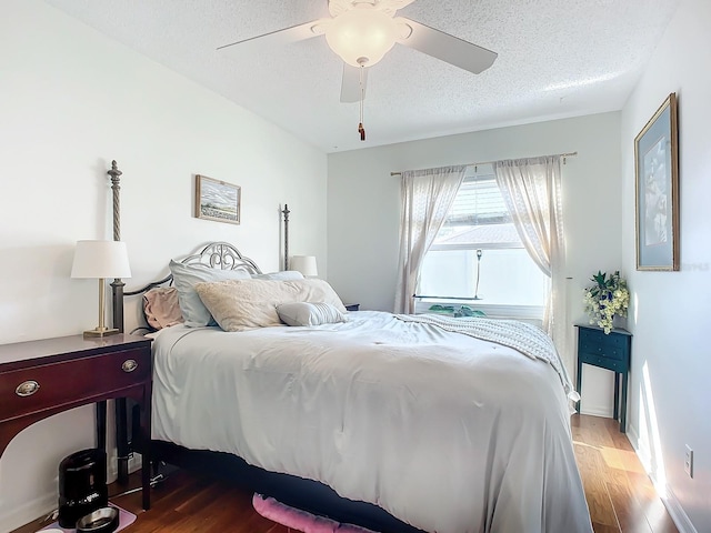 bedroom featuring ceiling fan, a textured ceiling, and hardwood / wood-style floors