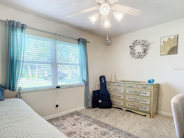 bedroom featuring a textured ceiling and ceiling fan