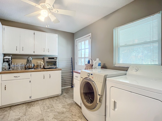 laundry area with ceiling fan, a textured ceiling, washer and clothes dryer, and laundry area