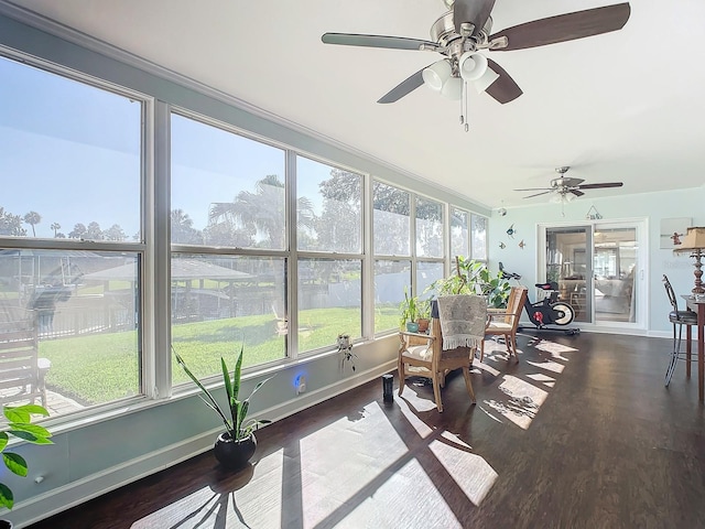 sunroom featuring ceiling fan