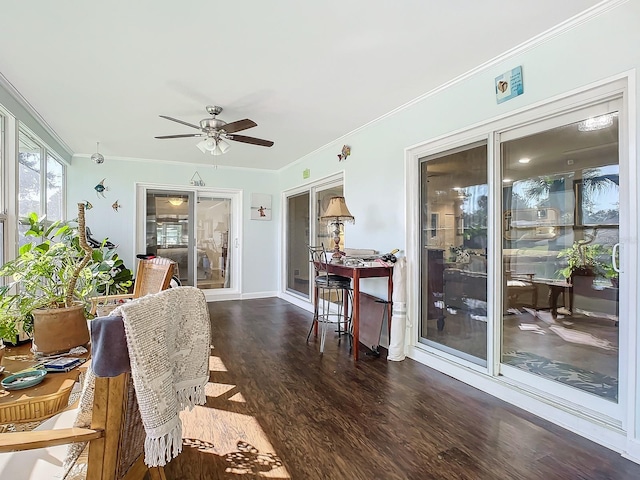 dining room with ornamental molding, dark wood-type flooring, and ceiling fan