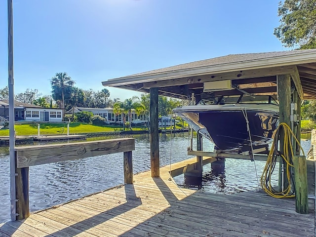 dock area featuring a yard and a water view