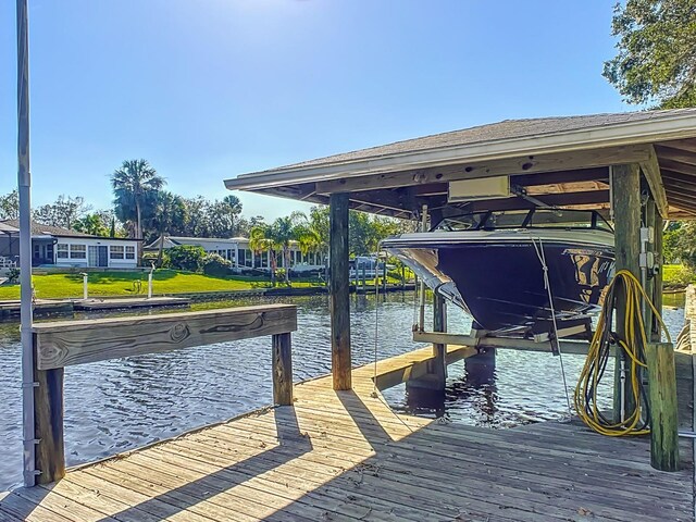 dock area featuring a water view and boat lift