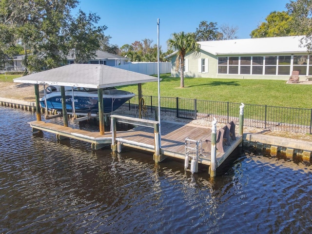 dock area featuring fence, a yard, a water view, and boat lift