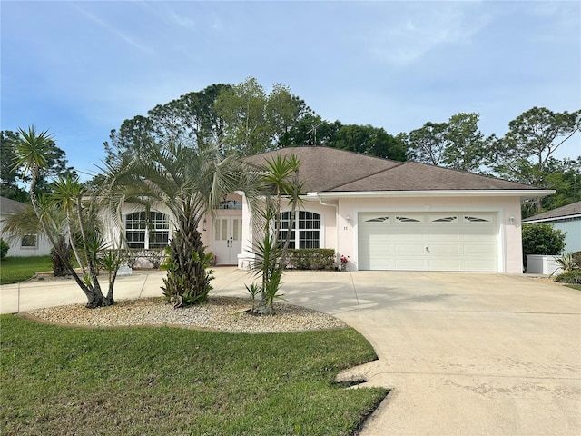 single story home with a garage and a front lawn