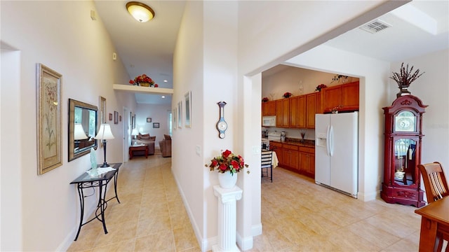 kitchen featuring white appliances, high vaulted ceiling, and light tile patterned floors