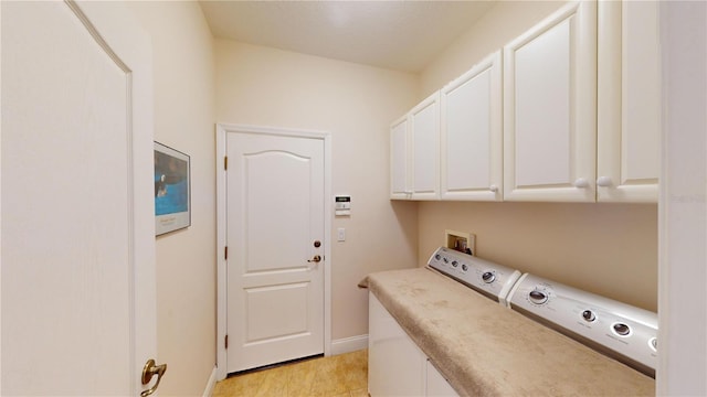 laundry room with cabinets, washing machine and dryer, and light tile patterned floors