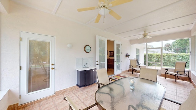 sunroom / solarium with beam ceiling and ceiling fan