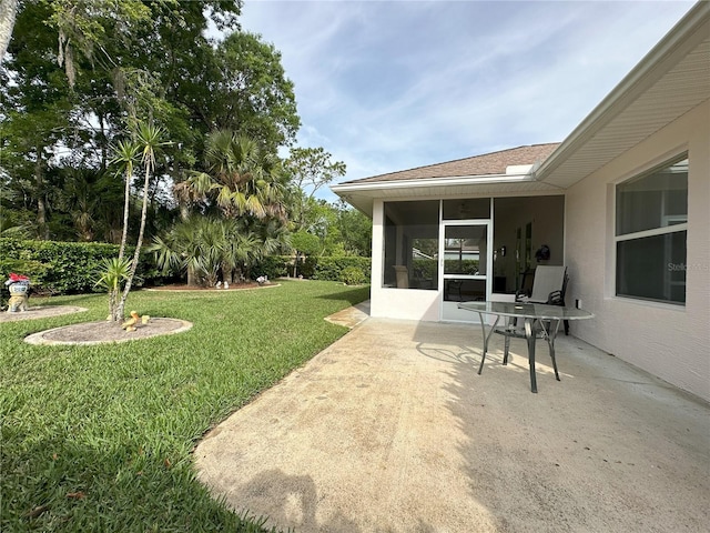 view of yard featuring a patio and a sunroom