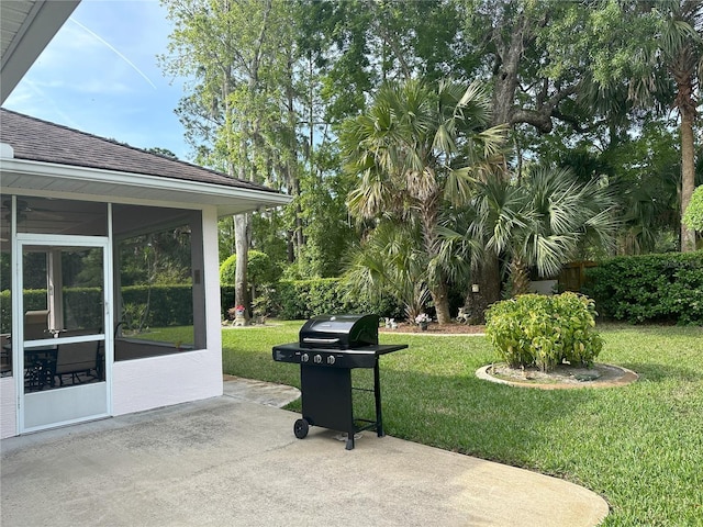 view of patio with a sunroom and a grill