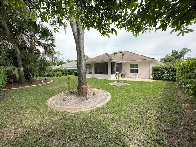 back of property featuring a yard and a sunroom