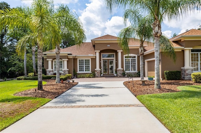 view of front of house with a front lawn and a garage