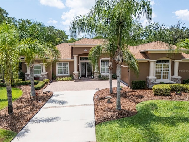 view of front of home with a front yard and a garage