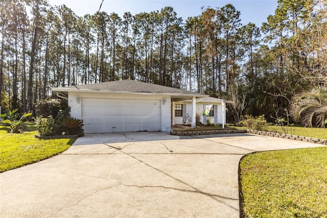 ranch-style house with a garage and a front lawn