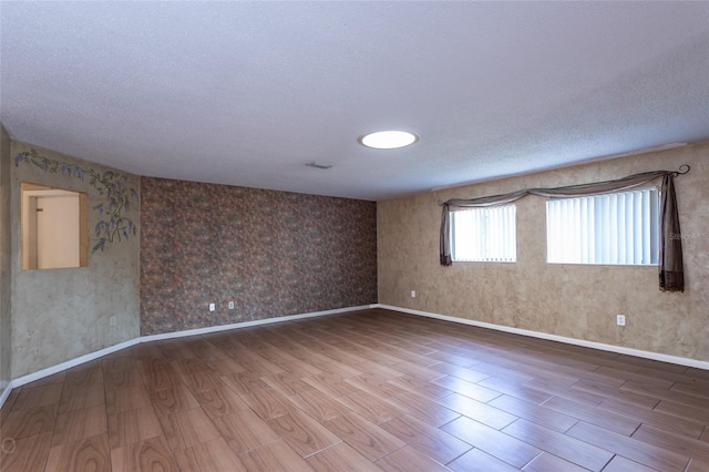 13 Washington Pl, Palm Coast, FL 32164 - spare room featuring baseboards, wood finish floors, and a textured ceiling