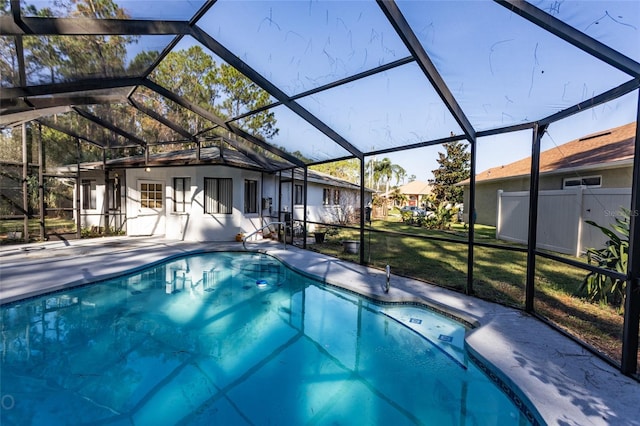 view of pool with a yard, a patio area, and a lanai