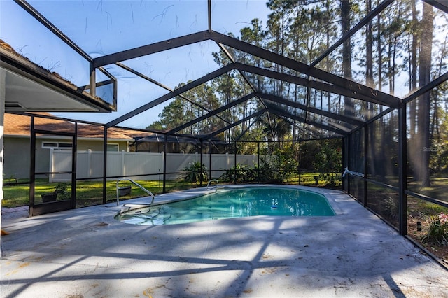 view of swimming pool featuring a patio and glass enclosure