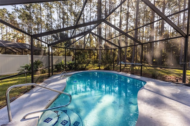 view of pool featuring a patio area and glass enclosure