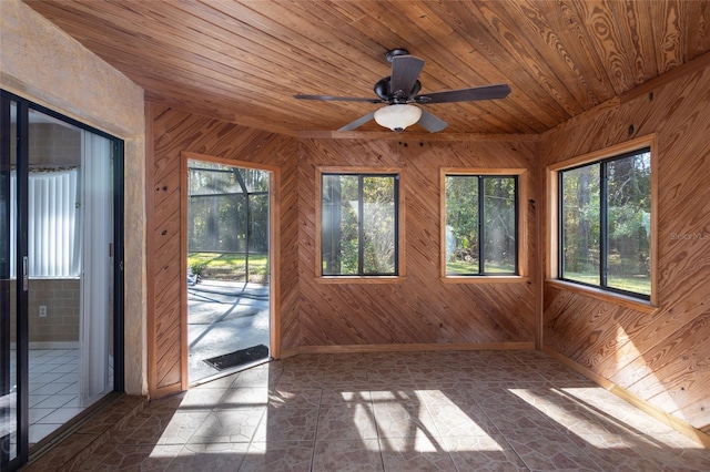 unfurnished sunroom featuring a wealth of natural light, vaulted ceiling, ceiling fan, and wooden ceiling