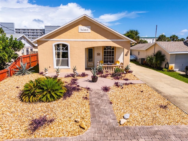 bungalow-style house with a porch and cooling unit