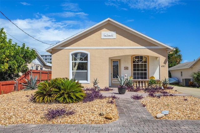 bungalow-style house featuring a porch and central AC