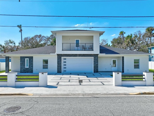 view of front of property with a garage and a balcony