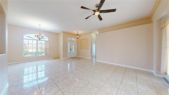 empty room with ornamental molding, light tile patterned flooring, and ceiling fan with notable chandelier