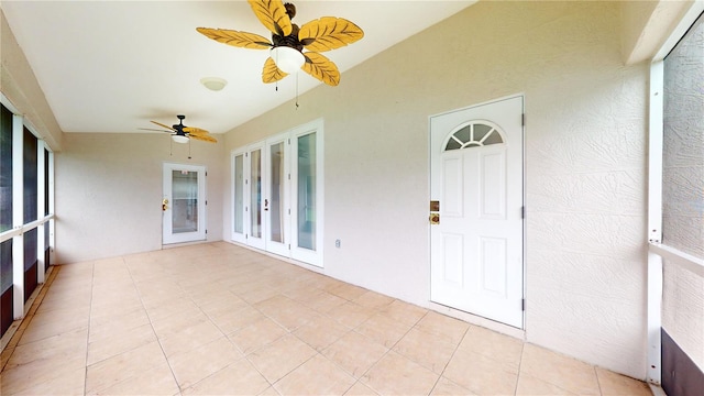 unfurnished sunroom with french doors and ceiling fan