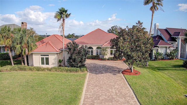 mediterranean / spanish-style house featuring a front lawn