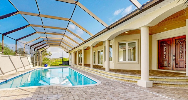 view of swimming pool with a patio and glass enclosure