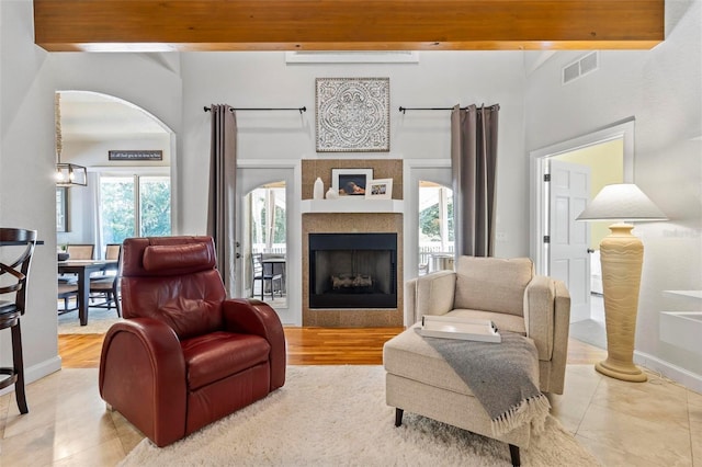 living room featuring light hardwood / wood-style floors and beamed ceiling