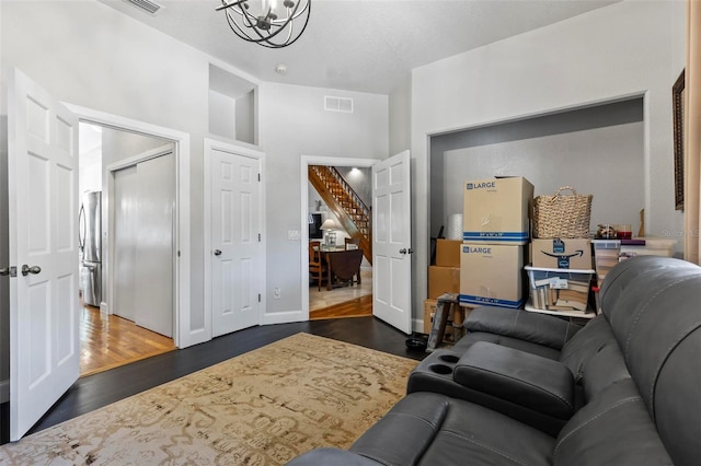 living room featuring a chandelier and dark hardwood / wood-style flooring