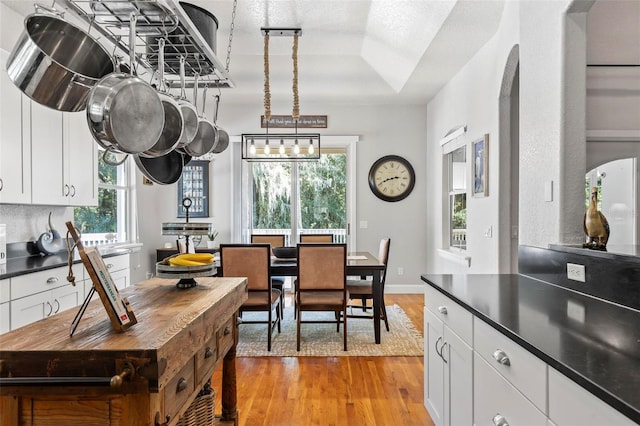 kitchen with pendant lighting, plenty of natural light, and white cabinets