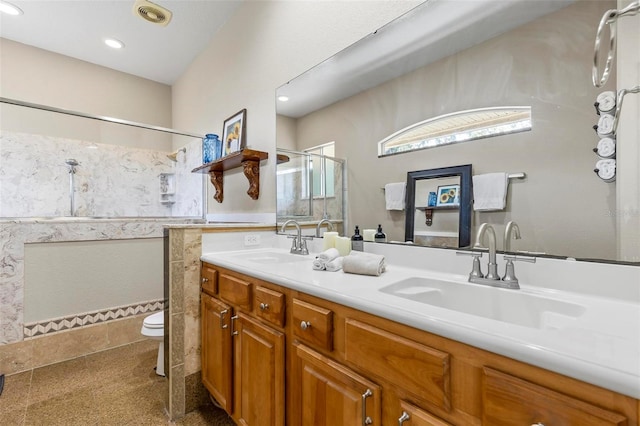 bathroom with vanity, toilet, and walk in shower