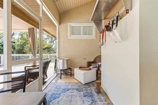 sunroom / solarium featuring vaulted ceiling