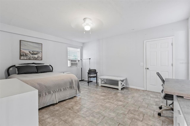 bedroom with cooling unit and ceiling fan