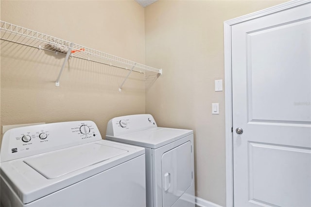 laundry room featuring separate washer and dryer