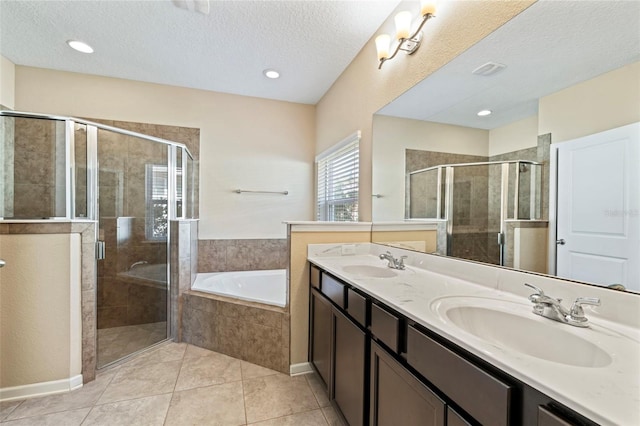 bathroom featuring a stall shower, a garden tub, and a sink