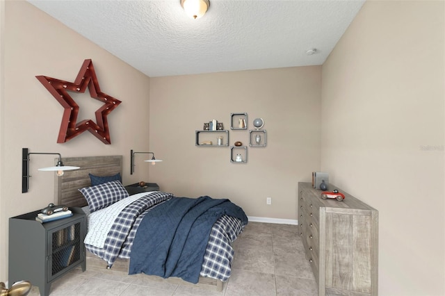 bedroom featuring light tile patterned flooring and a textured ceiling