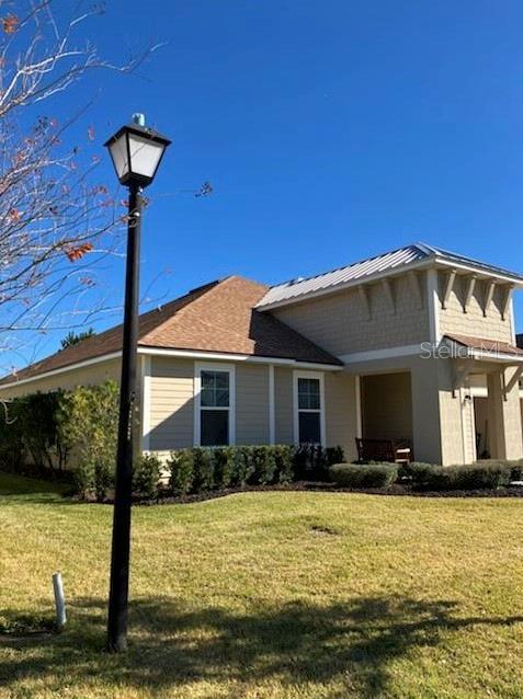 view of side of property with a yard