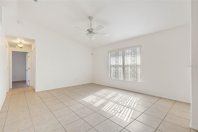 spare room featuring ceiling fan and light tile patterned floors