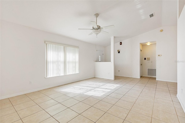 tiled empty room with vaulted ceiling and ceiling fan