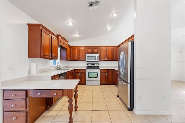 kitchen with lofted ceiling, kitchen peninsula, light tile patterned floors, sink, and stainless steel appliances