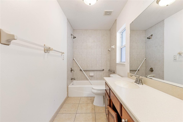 full bathroom featuring a textured ceiling, toilet, vanity, tiled shower / bath combo, and tile patterned floors